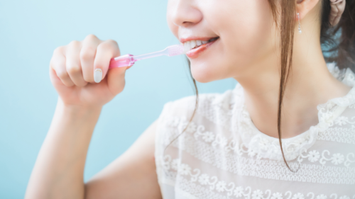 歯をブラシで磨く女性